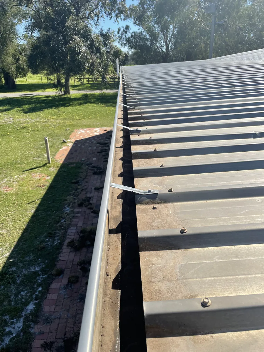 The same metal-roof gutter cleared after ProFlo vacuum cleaning, Perth